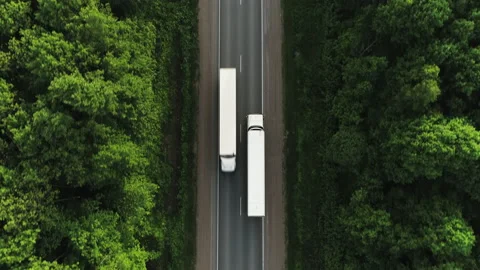 One Semi Truck with white trailer and cab driving / traveling on road Stock Footage