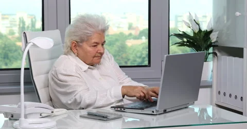 One Senior Female Working on Computer Old Woman Typing Laptop Home Office Room Stock Footage 67849902