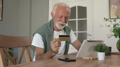 One senior man use digital tablet hold credit car shopping online Stock Footage 250356809