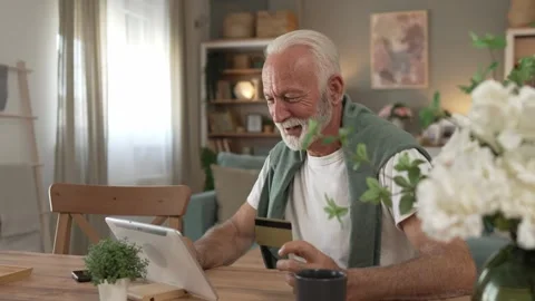 One senior man use digital tablet hold credit car shopping online Stock Footage 250356820