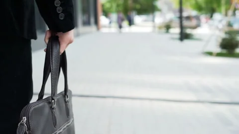 One serious manager hold in hand case with documents and walk slow motion close Stock Footage 199492023