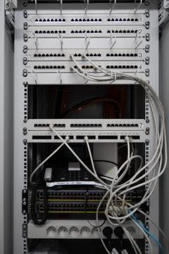 In one server rack are many patch panels and network cables and network switc Stock Photos