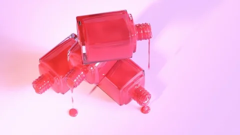 One shade of red nail polish spilled from stack of glass bottles. 4K HD Stock Footage 119986940