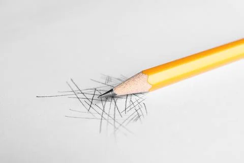 One sharp graphite pencil and scribbles on white background, closeup 写真素材