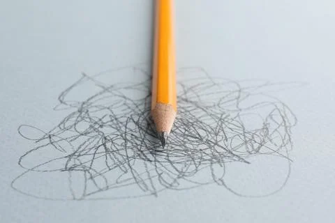 One sharp graphite pencil and scribbles on white background, closeup 스톡 사진