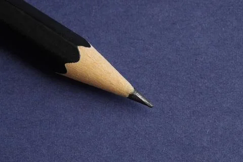 One sharp graphite pencil on blue background, closeup. Space for text 写真素材