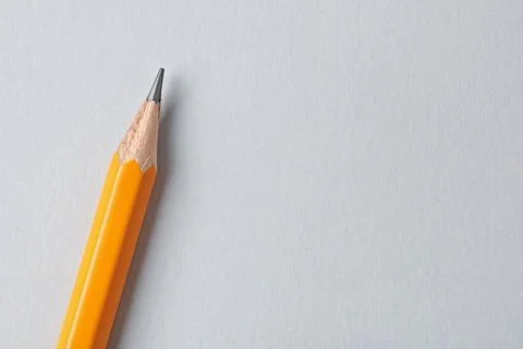 One sharp graphite pencil on grey background, top view. Space for text Stockfoto's