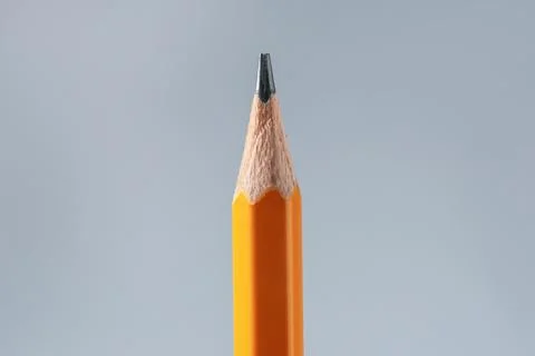 One sharp graphite pencil on grey background, closeup 写真素材
