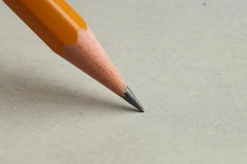 One sharp graphite pencil on light background, closeup. Space for text Foto stock
