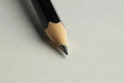 One sharp graphite pencil on light background, closeup 스톡 사진