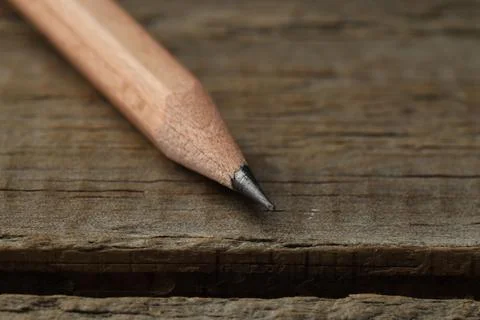 One sharp graphite pencil on wooden table, closeup. Space for text 스톡 사진