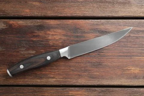 One sharp knife on wooden table, top view 写真素材