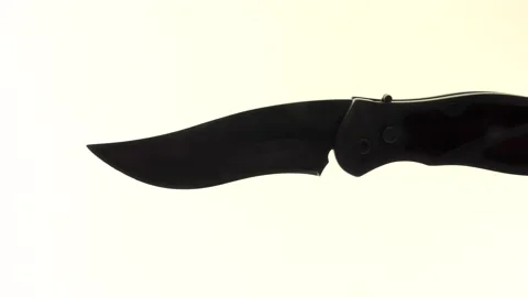 One sharp steel knife flies in front of the video camera Video stock 139970033
