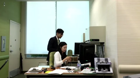 One side of bank teller processing documents on computer insideTD Bank Stock Footage 63602496