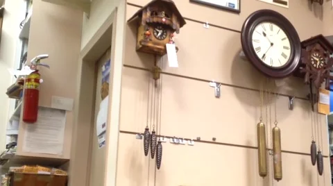 One side of clock and watch store with worker fixing watch Video stock 53006814