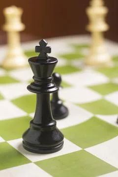 One side light on Black king chess piece. close up photo Foto stock