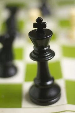One side light on Black king chess piece. close up photo Foto stock