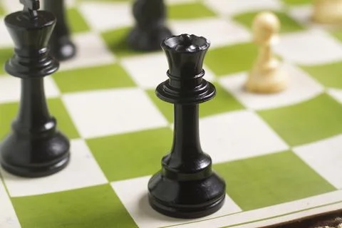 One side light on Black queen chess piece. close up photo Foto stock