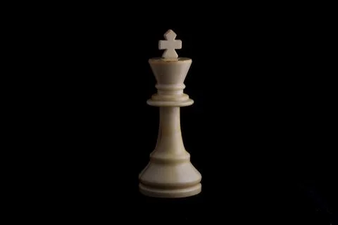 One side light on white king chess piece in black background Stock Photos