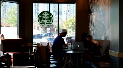 One side of people drinking coffee inside Starbucks store 動画素材 65501062