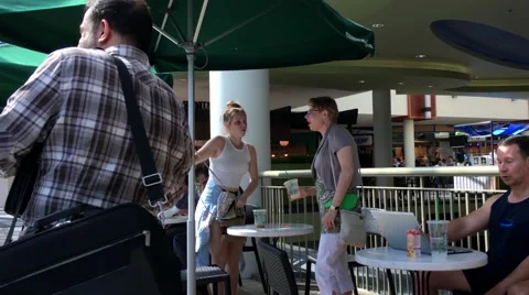 One side of people drinking coffee and chatting inside Starbucks store Stock Footage 66202561