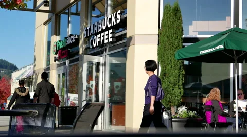 One side of people drinking Starbucks coffee on sunny day 스톡 동영상 57514064