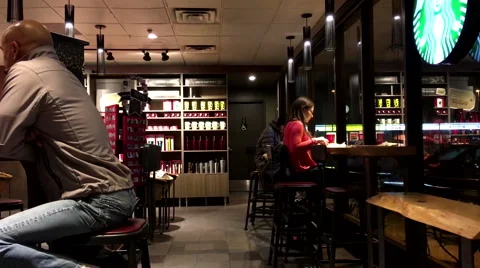 One side of people enjoying coffee at Starbucks Stock Footage 58636699