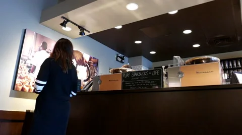 One side of people waiting for theire coffee inside Starbucks store Video stock 67437516