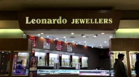 One side of people walking through Leonardo jewellers store Stock Footage 64911808