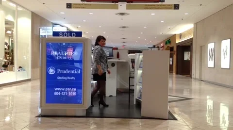 One side of Prudential sterling realty inside Coquitlam shopping mall Video stock 53063208