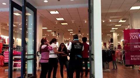 One side of store owner discussing with security about missing something Stock Footage 65057551