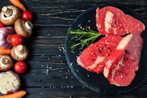 On one side of the table are vegetables on the other side of a beautiful juic 스톡 사진