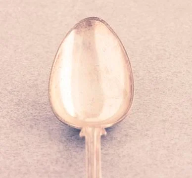 One silver spoon on stone table Stock Photos