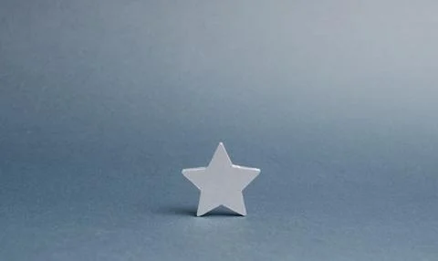 One silver star on a gray background. The concept began the way of business.. Stock Photos