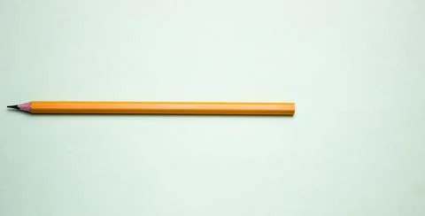 One simple pencil on a light background, space for text. Stock Photos