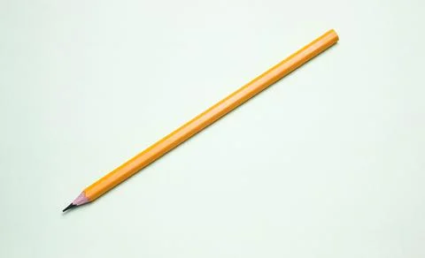 One simple pencil on a light background, space for text. Stock Photos