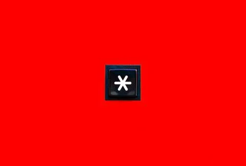One single asterisk symbol star sign square button key on bright red backgr.. Stock Photos