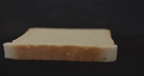 One slice of fresh fragrant tasty toast wheat bread, close-up, on a black 動画素材 130737663