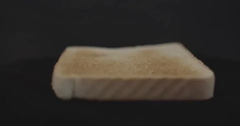 One slice of fresh fragrant tasty toast wheat bread, close-up, on a black Stock Footage 130741100