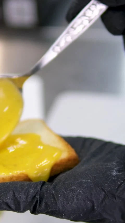 One slice of white square bread, with margarine spread, on white plate, isolated Stock Footage 281635604