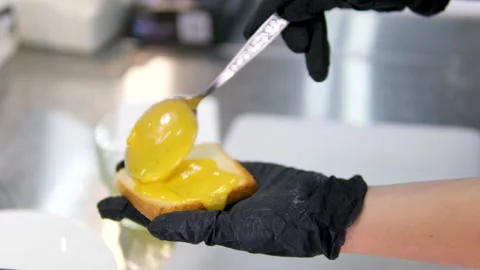 One slice of white square bread, with margarine spread, on white plate, isolated Stock Footage 281638639