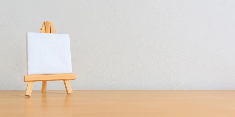 One small blank canvas on tiny wooden easel Stock Photos
