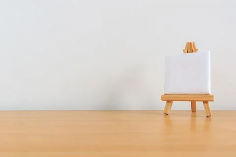 One small blank canvas on tiny wooden easel Stock Photos