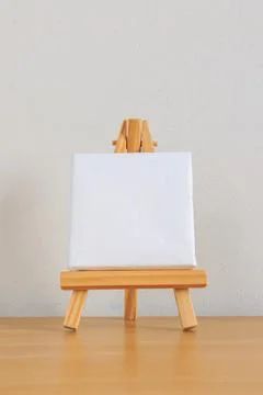 One small blank canvas on tiny wooden easel Stock Photos