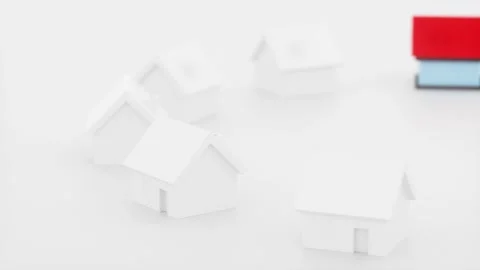 One small blue house with a red roof appears and stands out among many whit.. 스톡 동영상 327517012