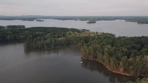 One small boat located in a cove of lake islands Stock Footage 129858883