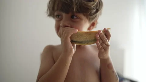 One small boy devouring yellow melon fruit indoors. Portrait face close up .. Stock Footage 232759221