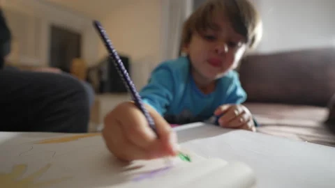 One small boy scribbling on paper with color pencil. Close up child hand co.. Stock Footage 236988652