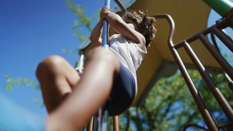 One small boy sliding down on pole at playground structure outside at park... Vídeo Stock 228862024