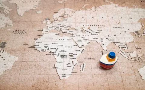 One Small ceramic ship on the world map Stock Photos